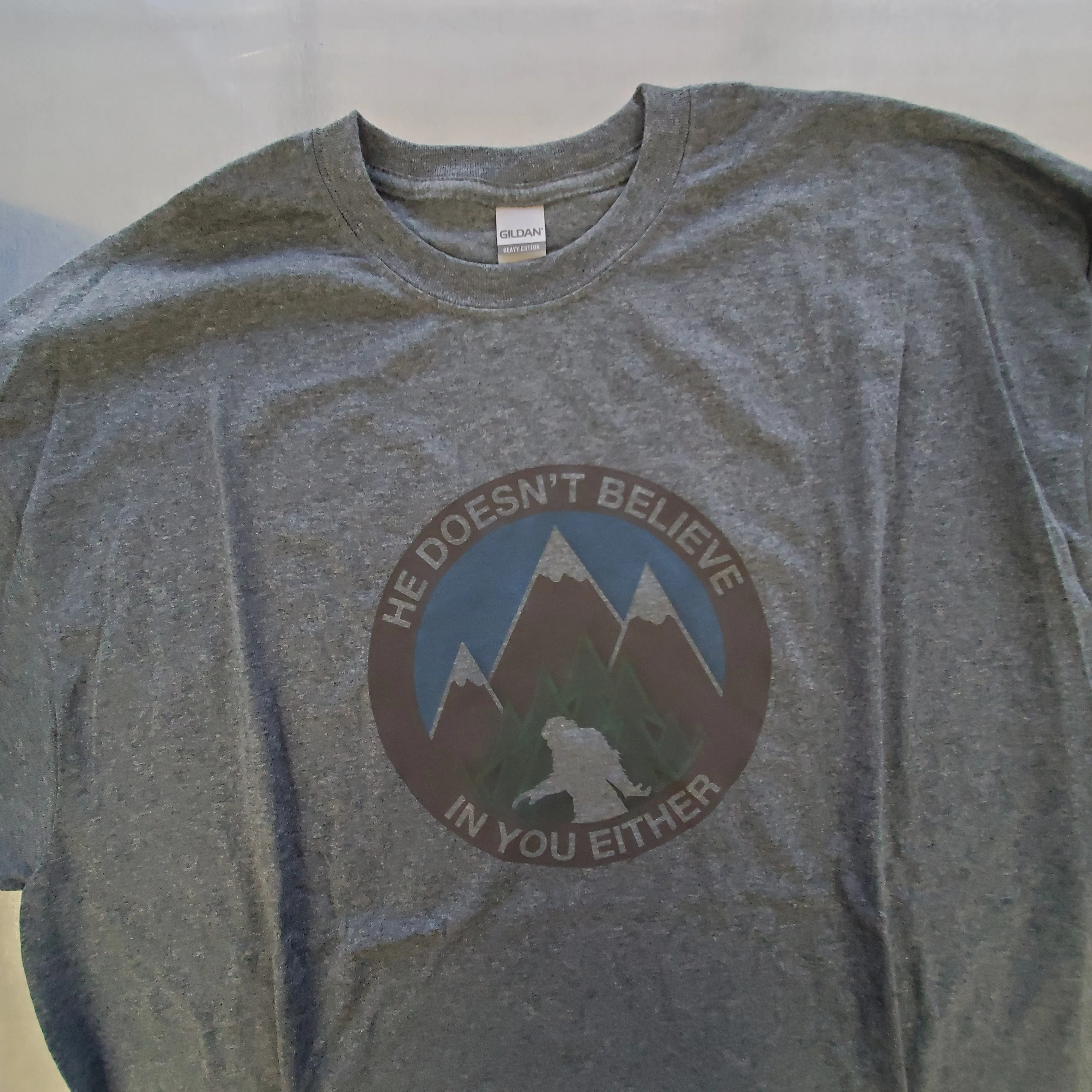He Doesn't Believe In You Either Bigfoot T-shirts